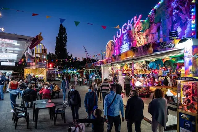 The summer funfair lit up on Place Carnot after dark