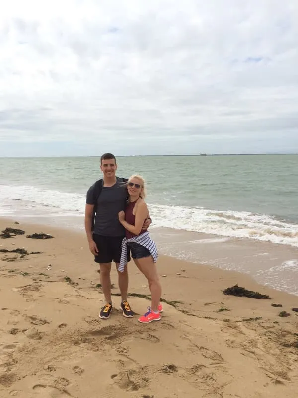 Tess and Jonny at the water’s edge on a bright day